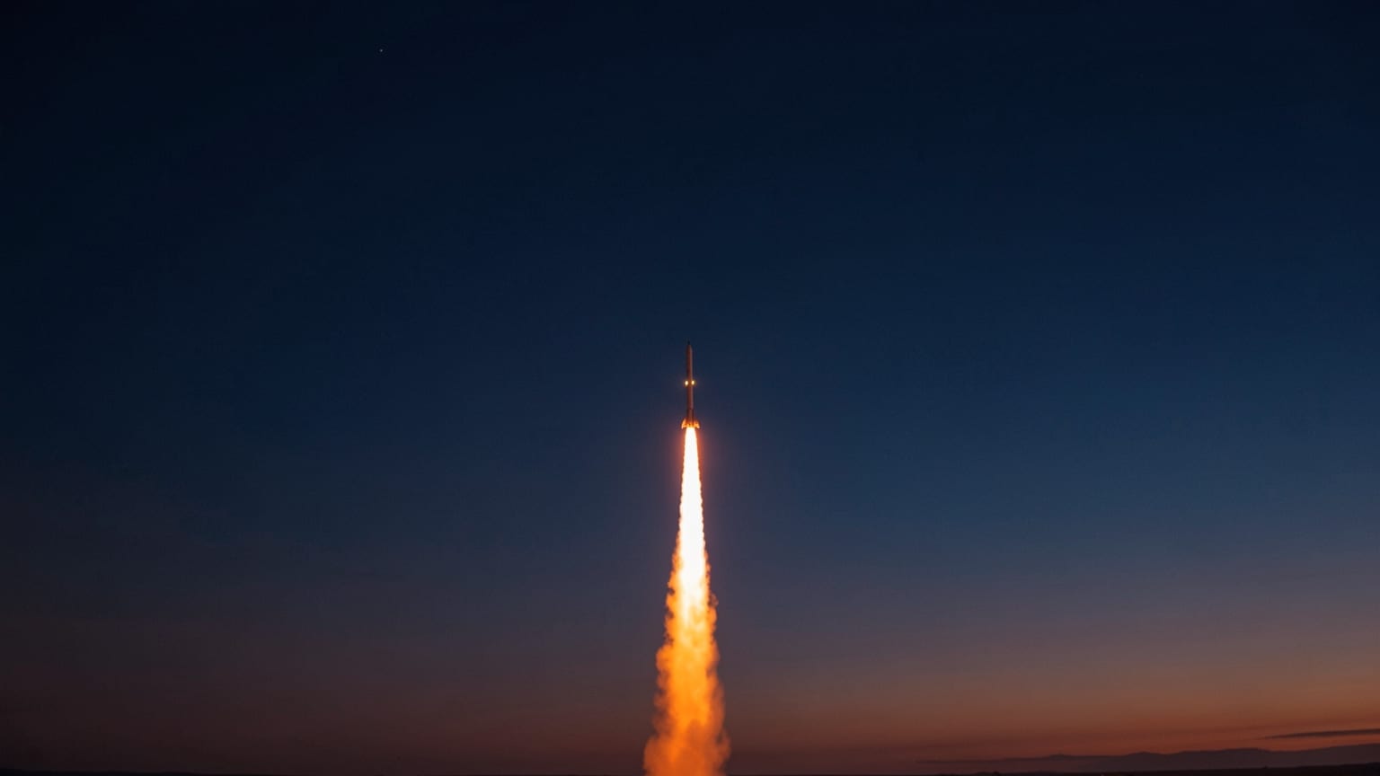 A rocket's orange exhaust trail curving up into a dark sky